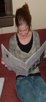 girl reading paper